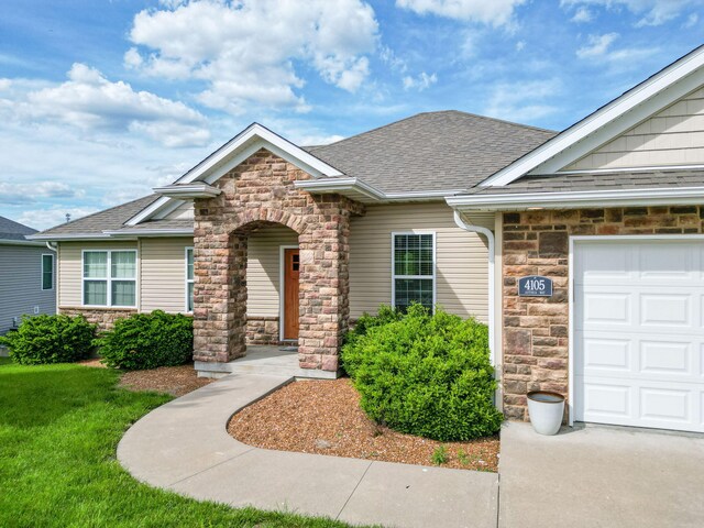 4105 Astoria Way, Columbia, MO 65203 - view of front facade featuring stone siding, an attached garage, and a shingled roof