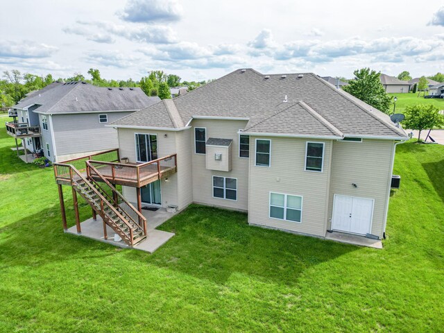 4105 Astoria Way, Columbia, MO 65203 - back of property with a patio, a shingled roof, a wooden deck, and a yard