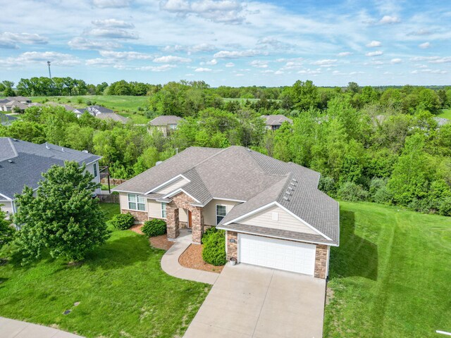 4105 Astoria Way, Columbia, MO 65203 - view of front of home featuring stone siding, an attached garage, driveway, and a front lawn