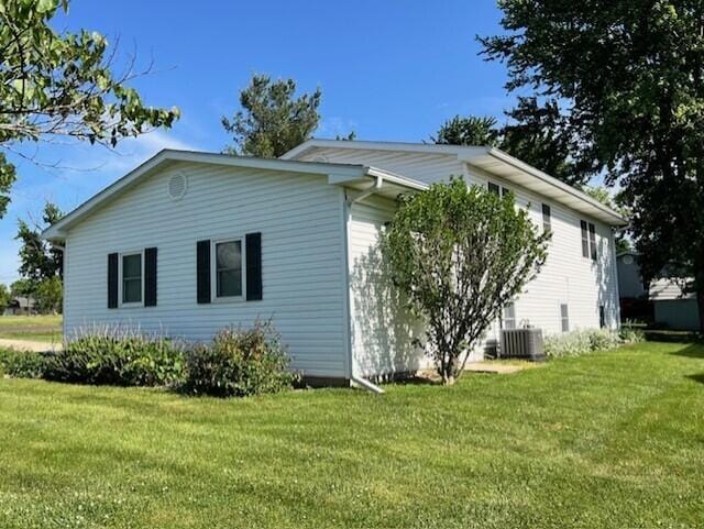 view of home's exterior with a yard and cooling unit
