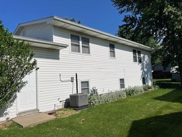 rear view of property featuring a yard