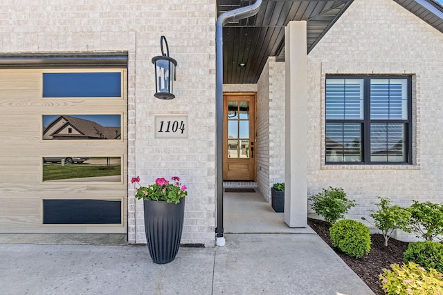 property entrance featuring brick siding