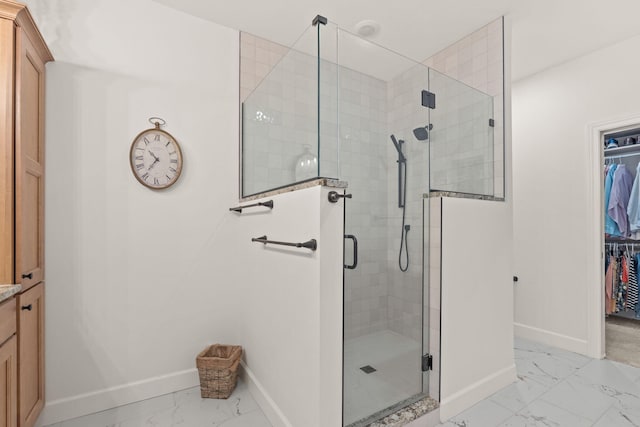1104 Caymus Ct, Columbia, MO 65201 - full bathroom with marble look tiles, baseboards, a shower stall, and a spacious closet