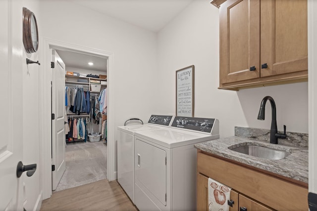 1104 Caymus Ct, Columbia, MO 65201 - laundry room featuring independent washer and dryer, cabinet space, and light wood finished floors