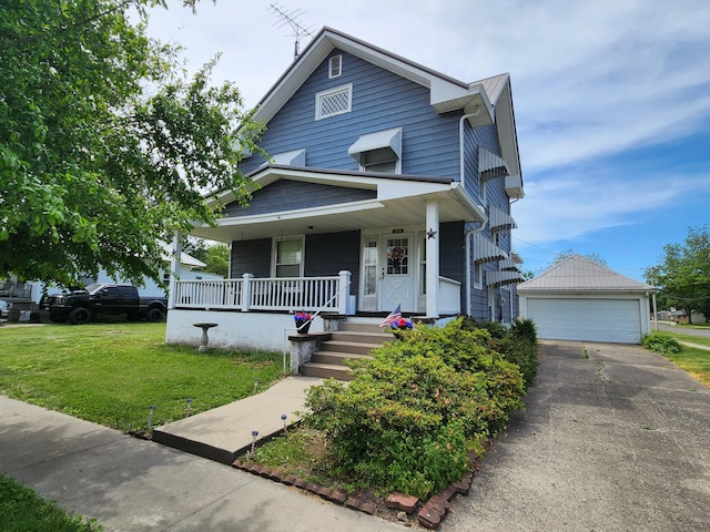 437 N Porter St, Slater, MO 65349 - american foursquare style home with covered porch, a front yard, and a detached garage