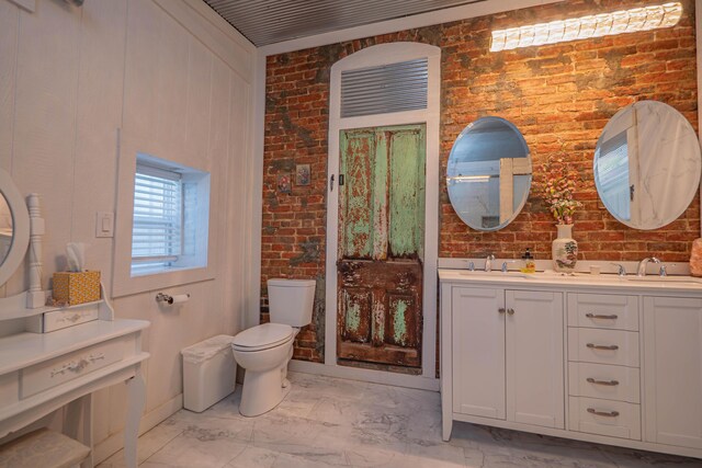 1081/2 E Broadway St, Brunswick, MO 65236 - full bath with marble finish flooring, brick wall, toilet, and double vanity