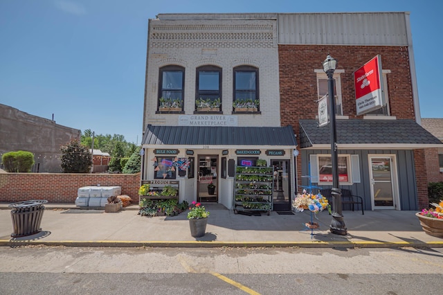 1081/2 E Broadway St, Brunswick, MO 65236 - view of front of property with brick siding and board and batten siding
