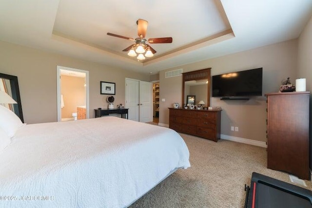 1200 Choctaw Ridge Dr, Holts Summit, MO 65043 - carpeted bedroom with a tray ceiling, baseboards, a ceiling fan, and ensuite bath