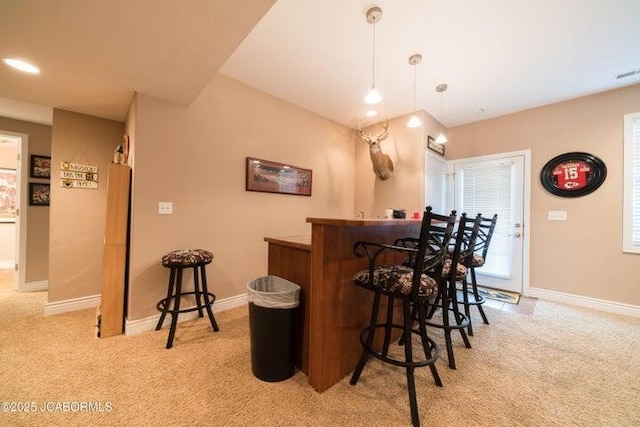 1200 Choctaw Ridge Dr, Holts Summit, MO 65043 - indoor dry bar featuring light carpet, baseboards, and decorative light fixtures