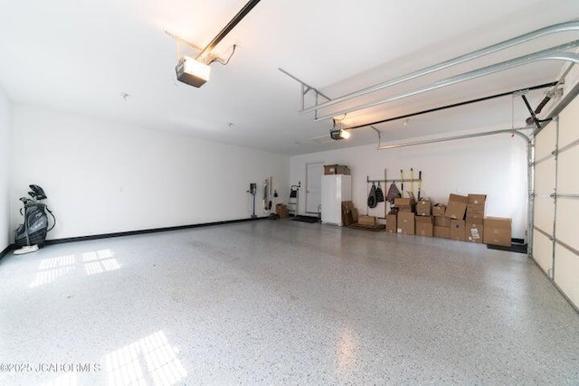 1200 Choctaw Ridge Dr, Holts Summit, MO 65043 - garage with a garage door opener and white fridge