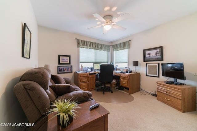 office space featuring ceiling fan and light colored carpet