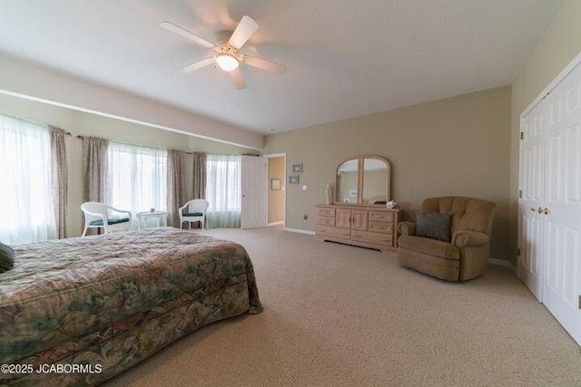 carpeted bedroom with baseboards and a ceiling fan