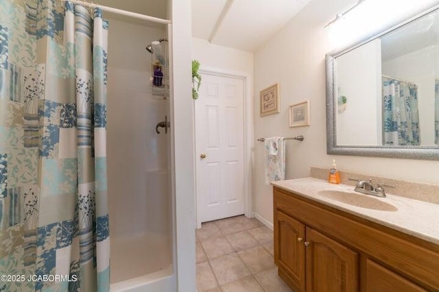 bathroom featuring a shower with shower curtain, tile patterned flooring, and vanity