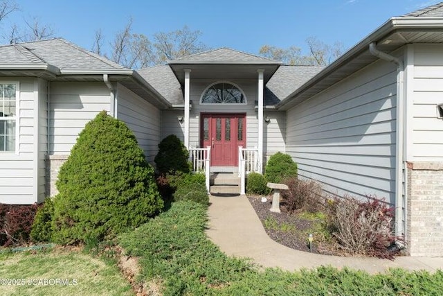 property entrance with roof with shingles