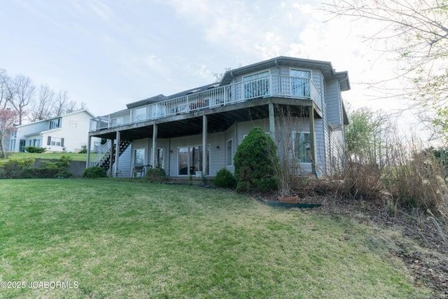 rear view of house with stairs, a yard, and a wooden deck