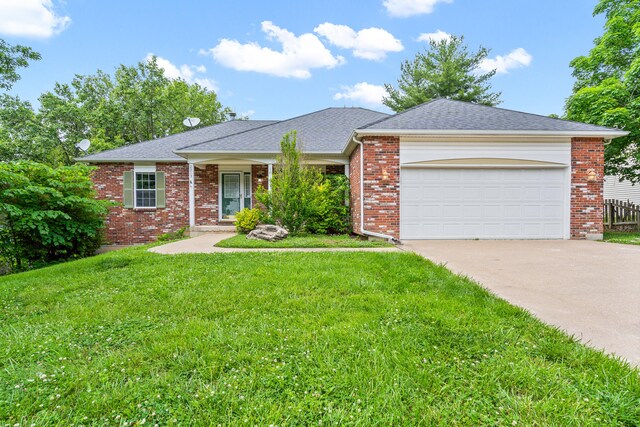 2313 Katy Ln, Columbia, MO 65203 - single story home with concrete driveway, a front yard, an attached garage, brick siding, and a shingled roof