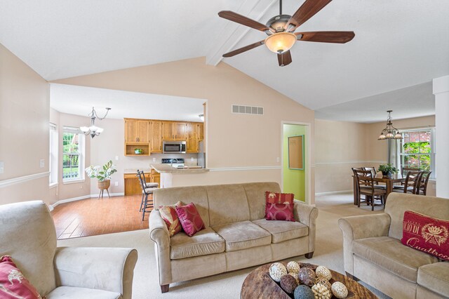 2313 Katy Ln, Columbia, MO 65203 - living room featuring a chandelier, beam ceiling, ceiling fan, light wood-style floors, and baseboards