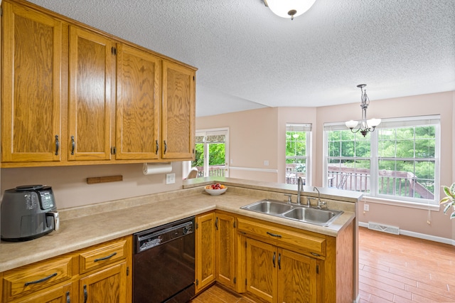 2313 Katy Ln, Columbia, MO 65203 - kitchen featuring black dishwasher, a sink, a peninsula, a textured ceiling, and light countertops