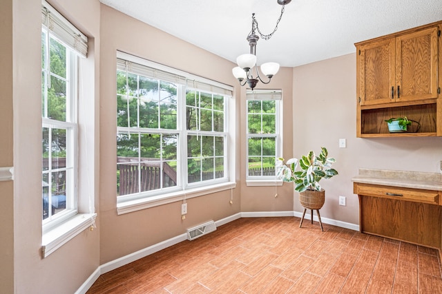 2313 Katy Ln, Columbia, MO 65203 - dining room with a chandelier, baseboards, and light wood-style flooring