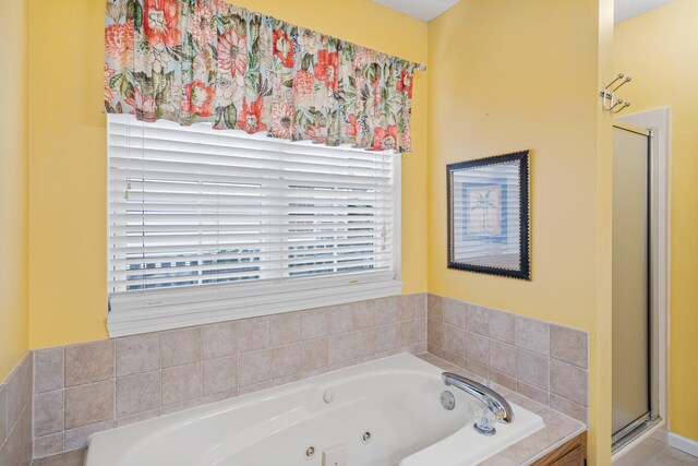 2313 Katy Ln, Columbia, MO 65203 - full bathroom featuring a shower stall, a tub with jets, and healthy amount of natural light