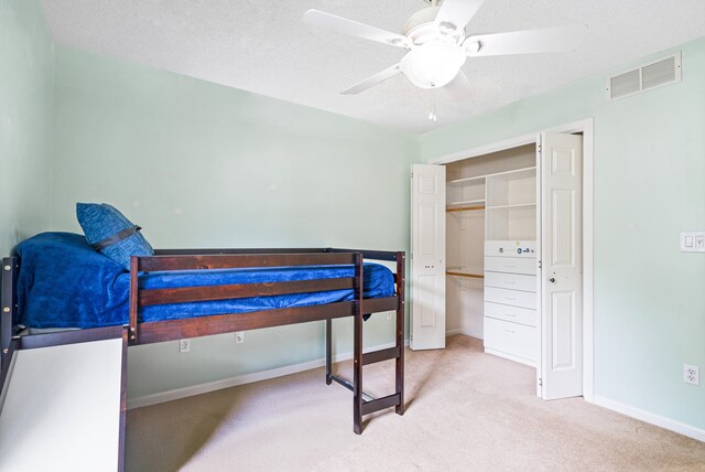 2313 Katy Ln, Columbia, MO 65203 - carpeted bedroom featuring a desk, baseboards, a closet, a ceiling fan, and a textured ceiling