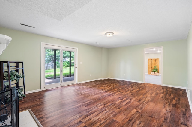 2313 Katy Ln, Columbia, MO 65203 - unfurnished living room featuring wood finished floors, a textured ceiling, and baseboards