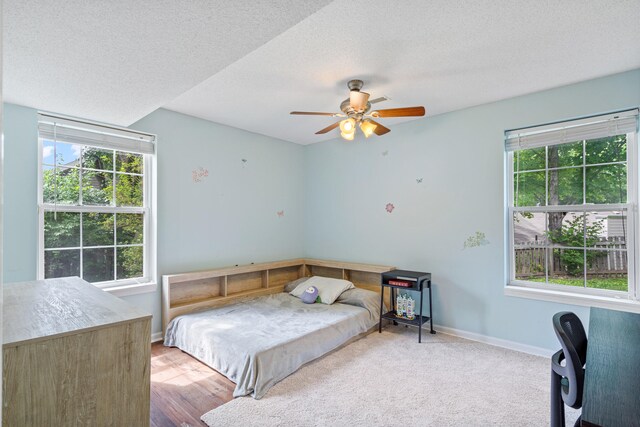 2313 Katy Ln, Columbia, MO 65203 - bedroom featuring a textured ceiling, baseboards, and a ceiling fan