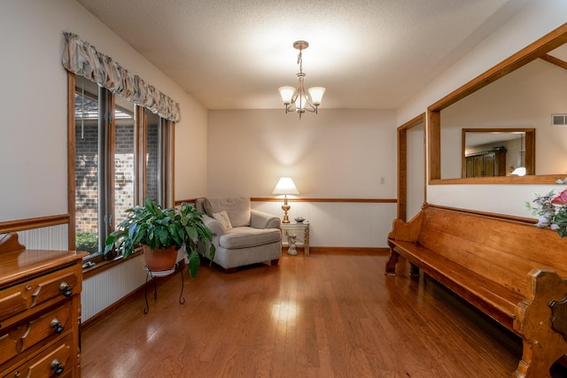 2512 Cimarron Dr, Columbia, MO 65203 - living area featuring wood finished floors, wainscoting, a chandelier, and baseboards