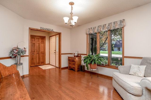 2512 Cimarron Dr, Columbia, MO 65203 - sitting room featuring wood finished floors, healthy amount of natural light, a chandelier, and wainscoting