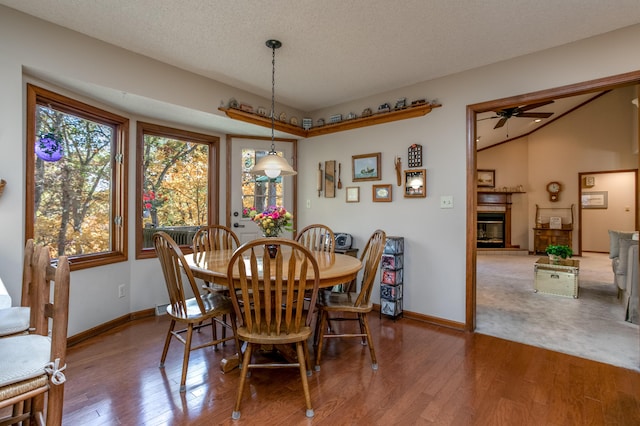 2512 Cimarron Dr, Columbia, MO 65203 - dining space with a ceiling fan, wood finished floors, baseboards, lofted ceiling, and a tile fireplace