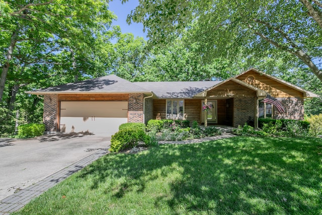 2512 Cimarron Dr, Columbia, MO 65203 - ranch-style house with brick siding, a garage, driveway, and a front yard