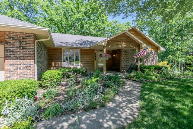 2512 Cimarron Dr, Columbia, MO 65203 - view of exterior entry featuring brick siding and a shingled roof