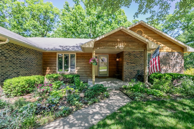 2512 Cimarron Dr, Columbia, MO 65203 - view of front of house with brick siding, a patio, and roof with shingles