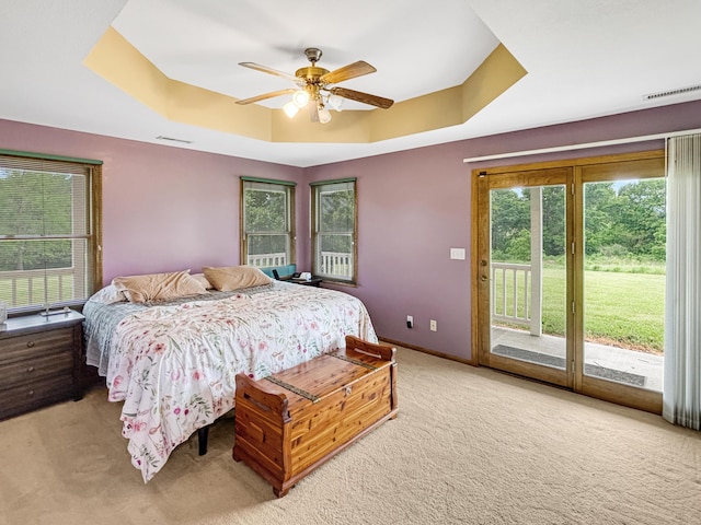 7495 E Schooler Rd, Centralia, MO 65240 - bedroom with a tray ceiling, light colored carpet, access to outside, and baseboards