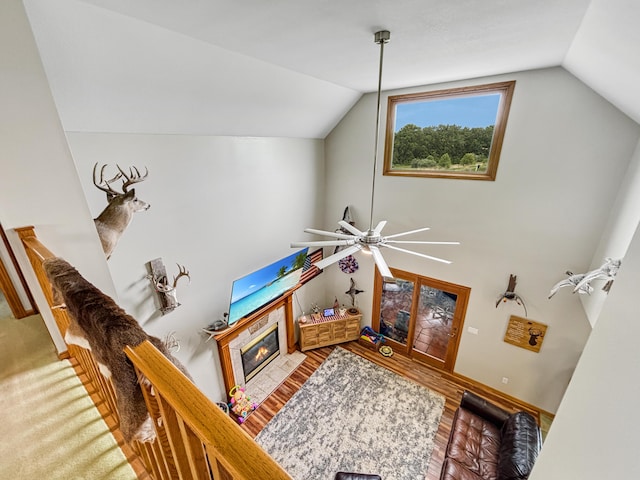 7495 E Schooler Rd, Centralia, MO 65240 - living room featuring lofted ceiling, a fireplace with flush hearth, wood finished floors, and ceiling fan