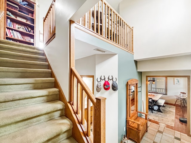7495 E Schooler Rd, Centralia, MO 65240 - stairway with a high ceiling and baseboards