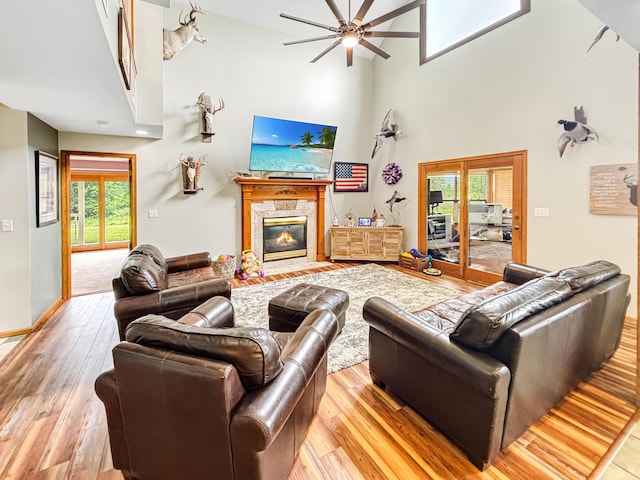 7495 E Schooler Rd, Centralia, MO 65240 - living area with a high ceiling, a ceiling fan, light wood-style floors, and a tile fireplace