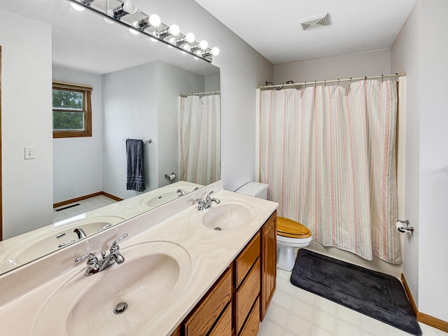 7495 E Schooler Rd, Centralia, MO 65240 - full bath featuring toilet, double vanity, tile patterned floors, and baseboards