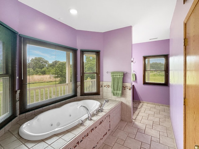 7495 E Schooler Rd, Centralia, MO 65240 - full bath with a whirlpool tub, stone tile flooring, and baseboards