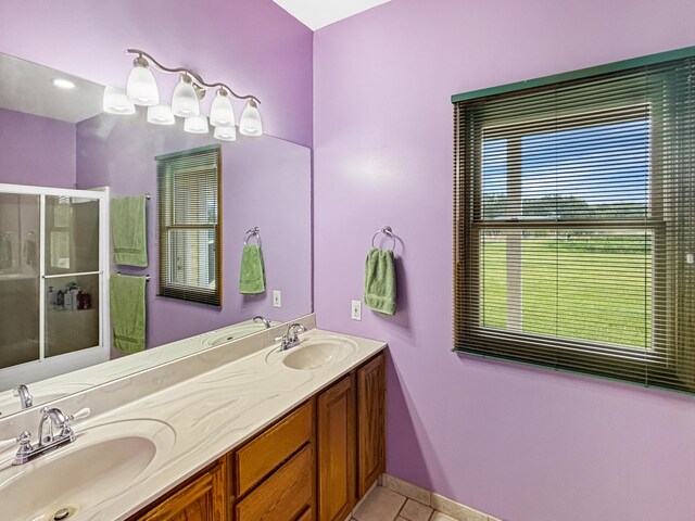 7495 E Schooler Rd, Centralia, MO 65240 - full bath with tile patterned floors, a stall shower, double vanity, and baseboards