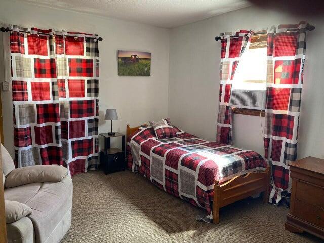 bedroom with carpet flooring and cooling unit