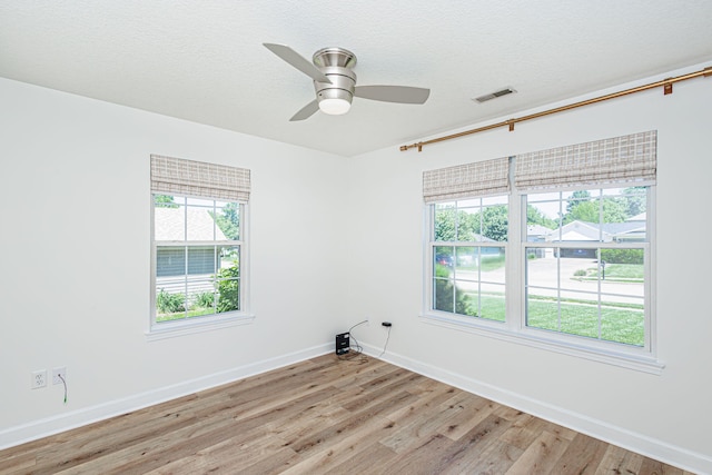 1050 Azoros Dr, Columbia, MO 65203 - spare room featuring light wood finished floors, baseboards, healthy amount of natural light, a ceiling fan, and a textured ceiling