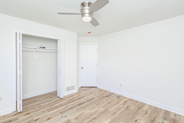 1050 Azoros Dr, Columbia, MO 65203 - unfurnished bedroom featuring wood finished floors, baseboards, a ceiling fan, and a closet