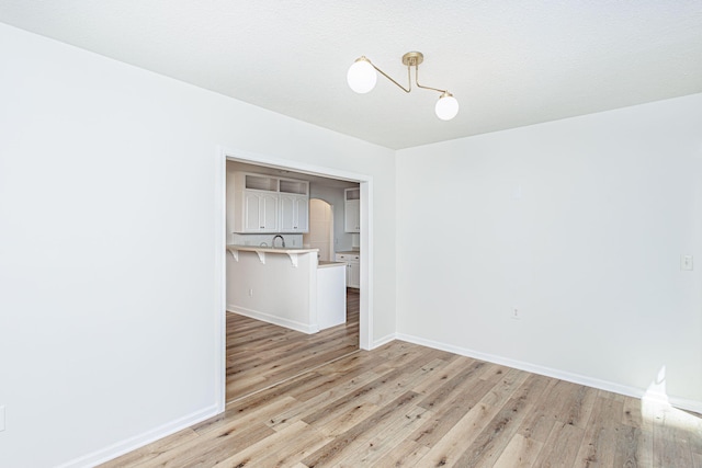 1050 Azoros Dr, Columbia, MO 65203 - empty room with light wood-style flooring, baseboards, and a sink
