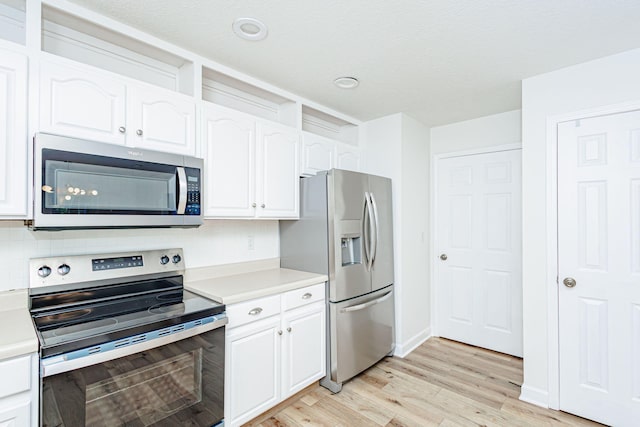 1050 Azoros Dr, Columbia, MO 65203 - kitchen with stainless steel appliances, light countertops, and white cabinetry
