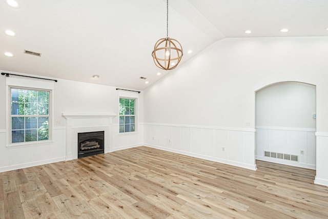 1050 Azoros Dr, Columbia, MO 65203 - unfurnished living room with a wainscoted wall, wood finished floors, lofted ceiling, plenty of natural light, and a fireplace