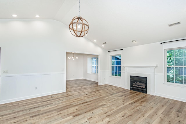 1050 Azoros Dr, Columbia, MO 65203 - unfurnished living room featuring a chandelier, lofted ceiling, wainscoting, wood finished floors, and a fireplace