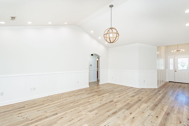 1050 Azoros Dr, Columbia, MO 65203 - unfurnished living room featuring a chandelier, wainscoting, light wood finished floors, arched walkways, and recessed lighting