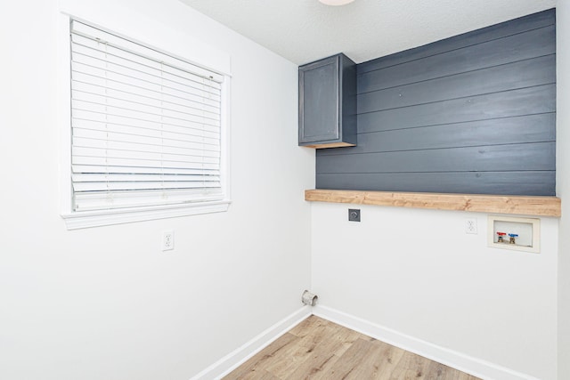 1050 Azoros Dr, Columbia, MO 65203 - laundry room with hookup for an electric dryer, baseboards, hookup for a washing machine, light wood-type flooring, and cabinet space