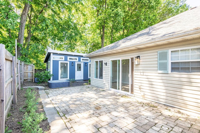 1050 Azoros Dr, Columbia, MO 65203 - fenced backyard featuring a patio area and an outbuilding